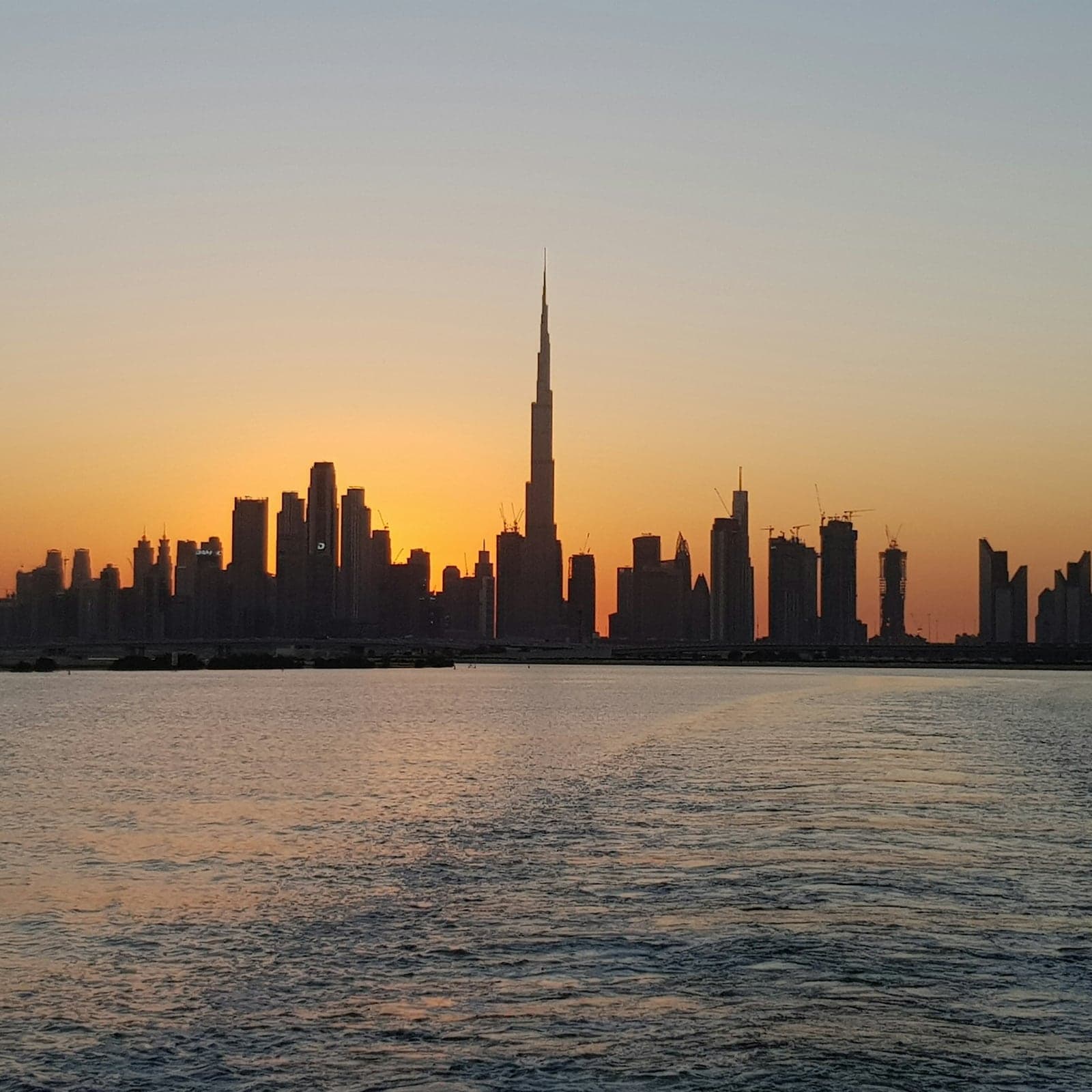 Dubai skyline across the water at dusk