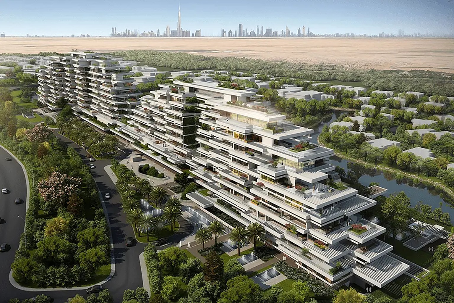 Aerial view of terraced residences at Al Barari among gardens and water, with the Dubai skyline beyond